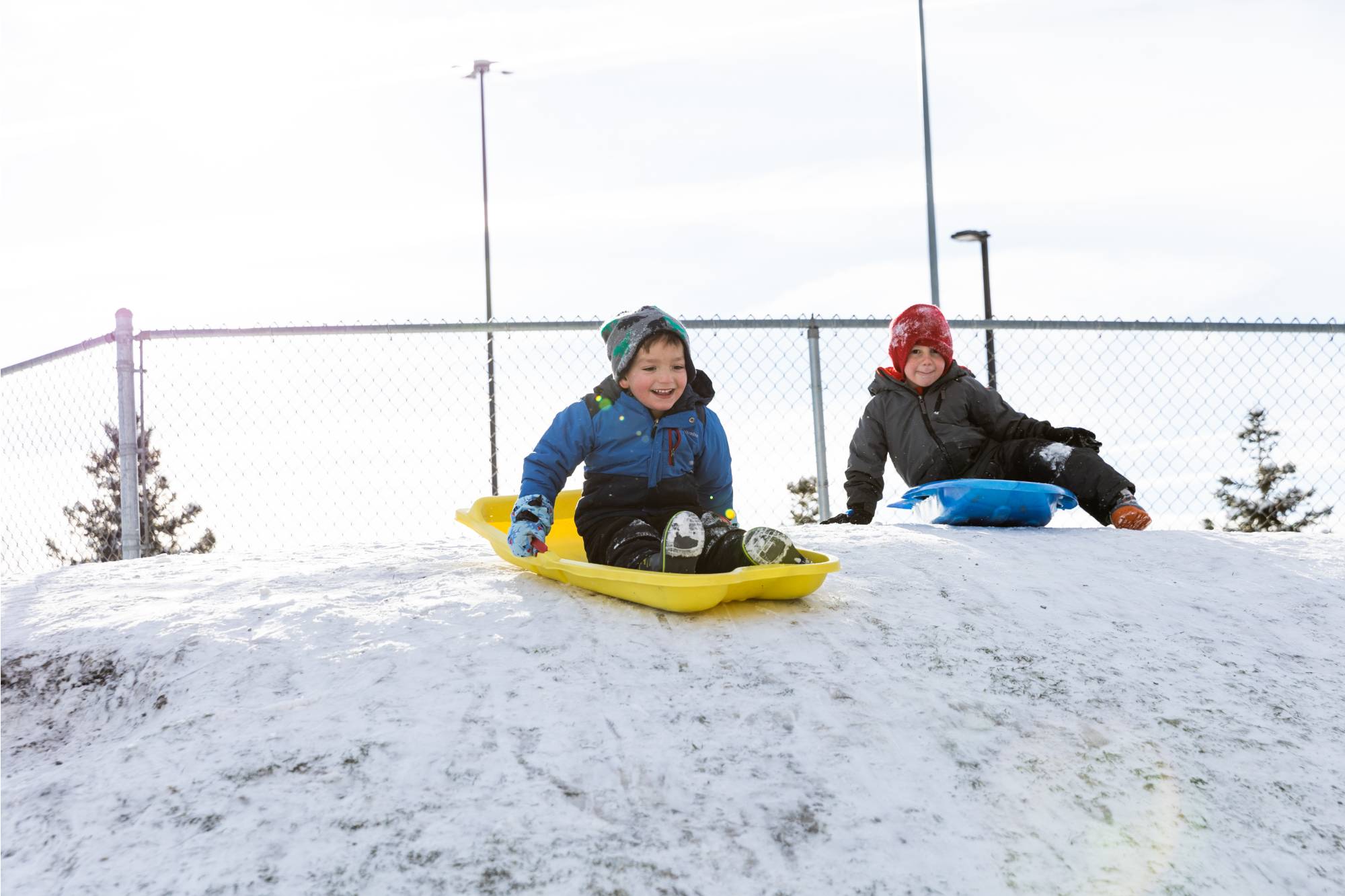 Kids playing on a sledding hill at the Children's Enrichment Center